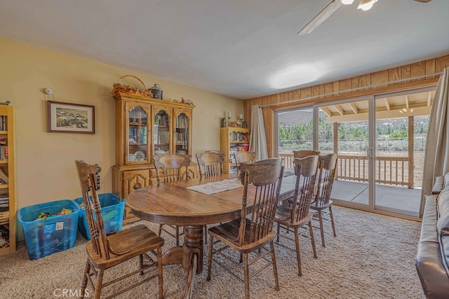 carpeted dining area featuring ceiling fan