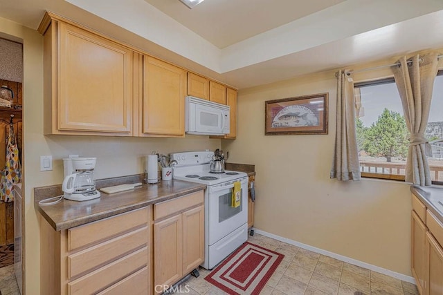 kitchen featuring light brown cabinets and white appliances