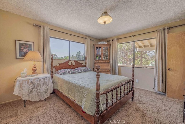 bedroom featuring a textured ceiling and carpet floors