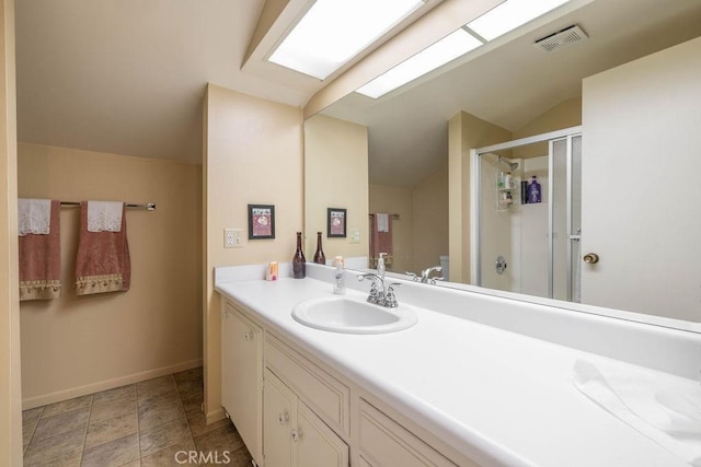 bathroom with toilet, vanity, vaulted ceiling, and an enclosed shower