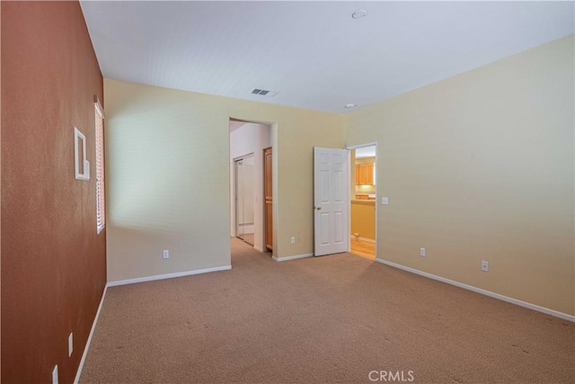 unfurnished bedroom featuring light carpet