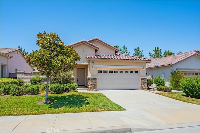 mediterranean / spanish home featuring a garage and a front lawn