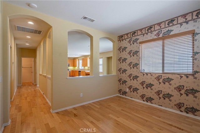 spare room with light hardwood / wood-style flooring