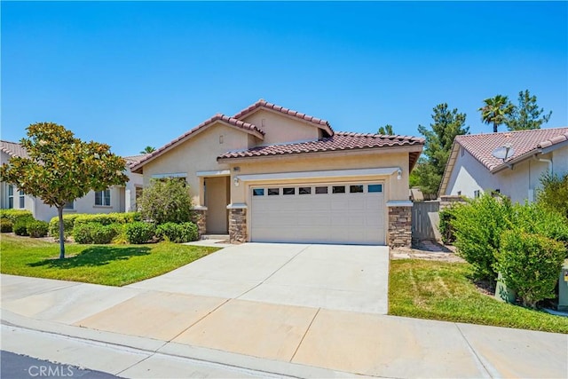 mediterranean / spanish home with a garage and a front yard