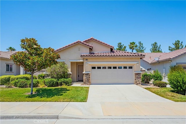 mediterranean / spanish-style house with a garage and a front lawn