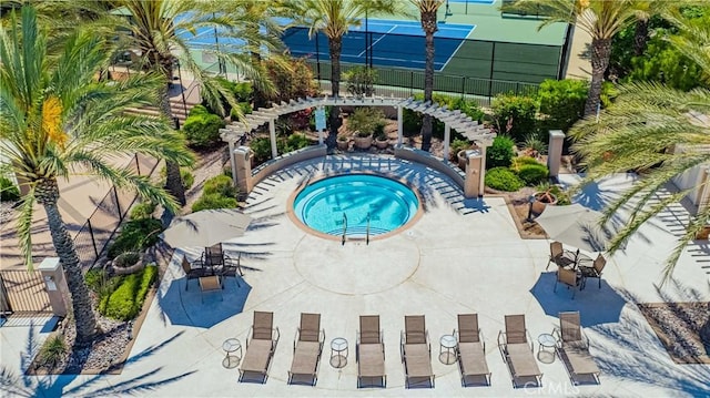 view of swimming pool featuring a community hot tub and a patio area