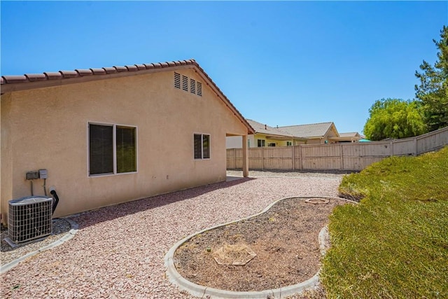 back of house with central AC and a patio