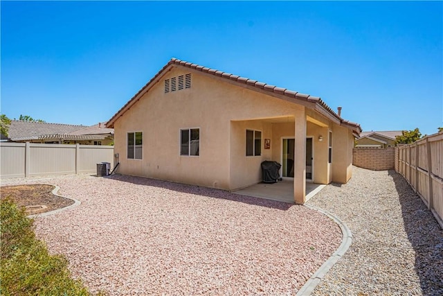 rear view of house featuring a patio and central air condition unit