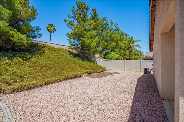 view of yard featuring central AC unit and a patio area