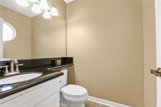 bathroom featuring tile patterned flooring, vanity, and toilet