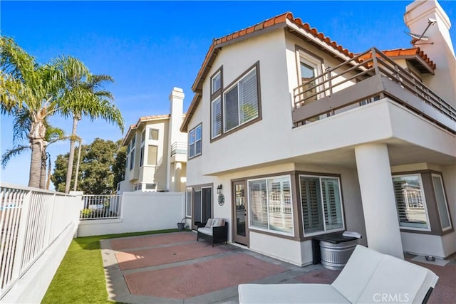 back of house featuring a patio area and a balcony