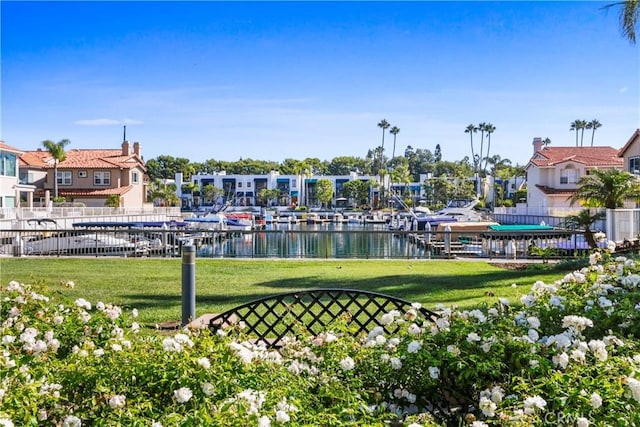 view of community with a water view and a yard