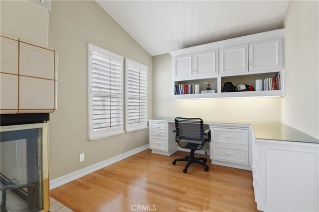 home office featuring light hardwood / wood-style flooring and lofted ceiling