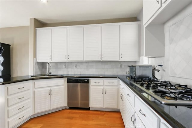 kitchen featuring sink, white cabinets, stainless steel appliances, and light hardwood / wood-style floors