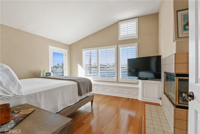 bedroom featuring light hardwood / wood-style flooring and vaulted ceiling