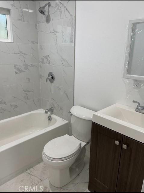 full bathroom featuring toilet, vanity, and tiled shower / bath