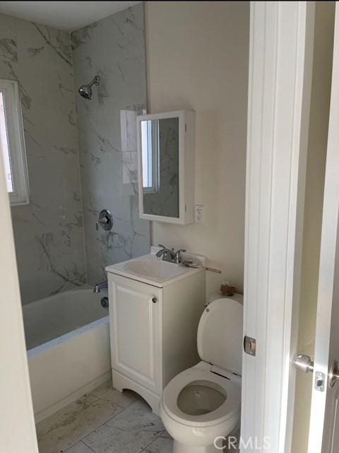 full bathroom with toilet, vanity, tiled shower / bath combo, and plenty of natural light