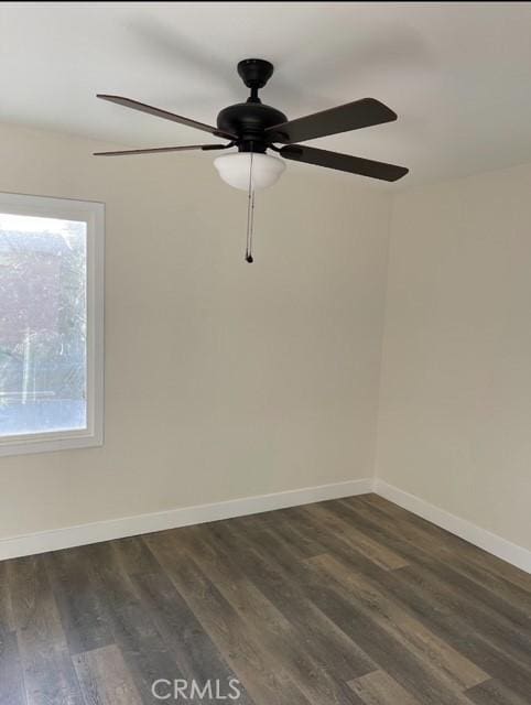 spare room with ceiling fan and dark wood-type flooring