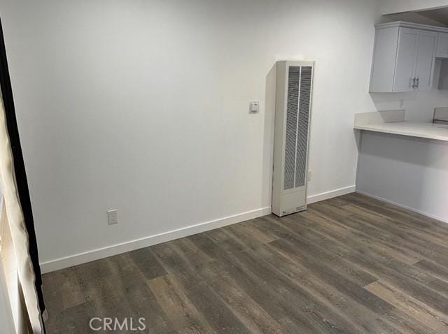 unfurnished dining area featuring dark hardwood / wood-style flooring