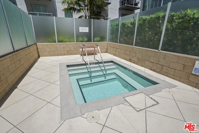 view of pool featuring a hot tub