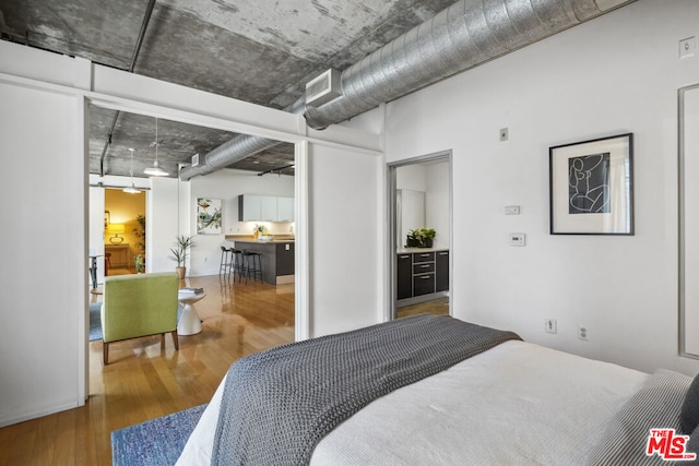 bedroom with hardwood / wood-style floors