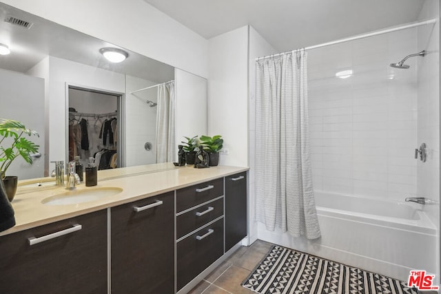 bathroom with tile patterned floors, vanity, and shower / tub combo