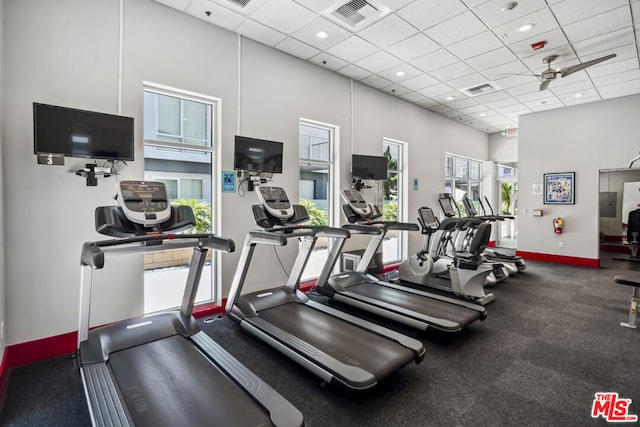 exercise room featuring a drop ceiling and ceiling fan