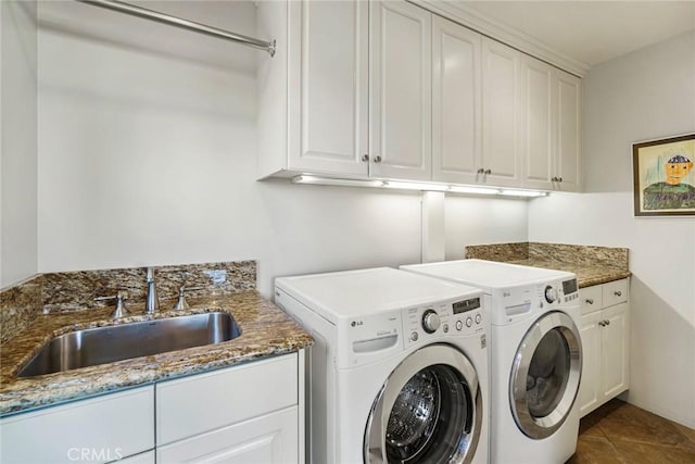 clothes washing area with cabinets, sink, tile patterned flooring, and independent washer and dryer