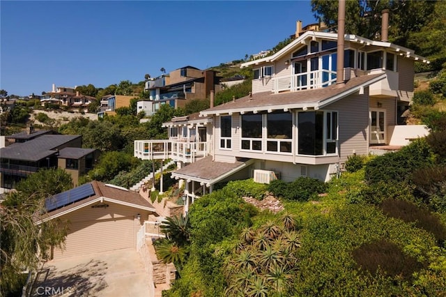 rear view of house featuring solar panels