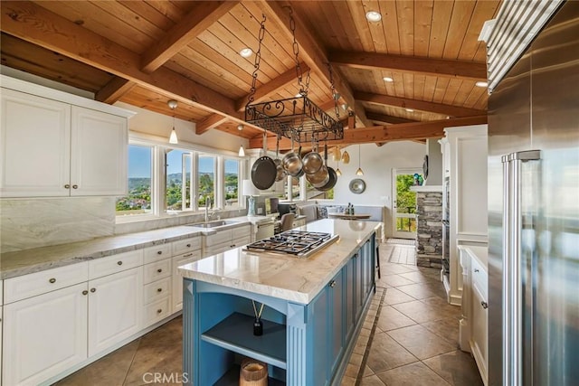 kitchen with hanging light fixtures, a center island, white cabinets, and appliances with stainless steel finishes