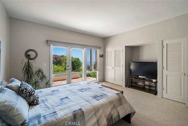 carpeted bedroom with french doors and access to exterior