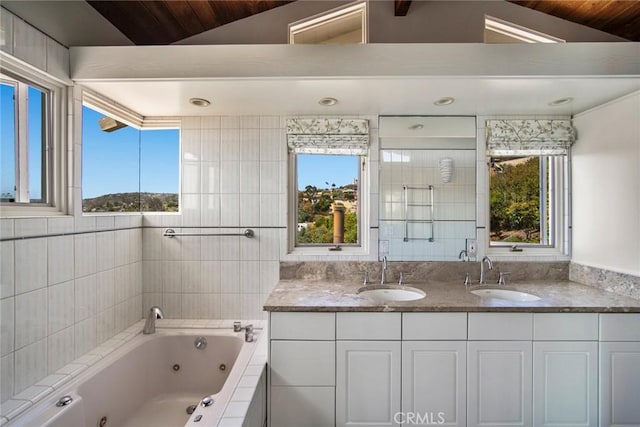 bathroom featuring vanity, vaulted ceiling, and independent shower and bath