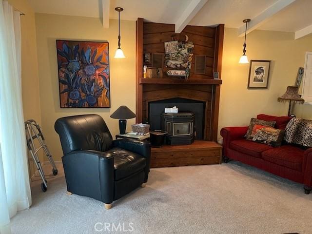 carpeted living room with beamed ceiling and a wood stove