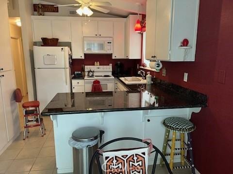 kitchen with white cabinetry, white appliances, kitchen peninsula, and a kitchen bar