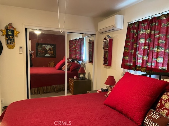 bedroom featuring a closet and an AC wall unit