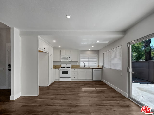 kitchen with white cabinets, dark hardwood / wood-style floors, white appliances, and sink