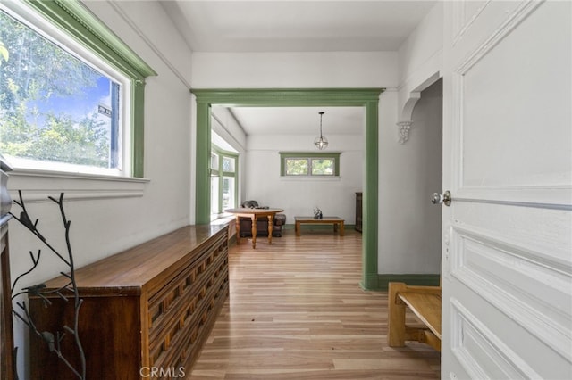 corridor with light hardwood / wood-style flooring