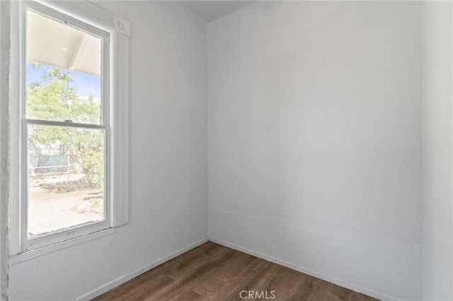 unfurnished room featuring dark wood-type flooring