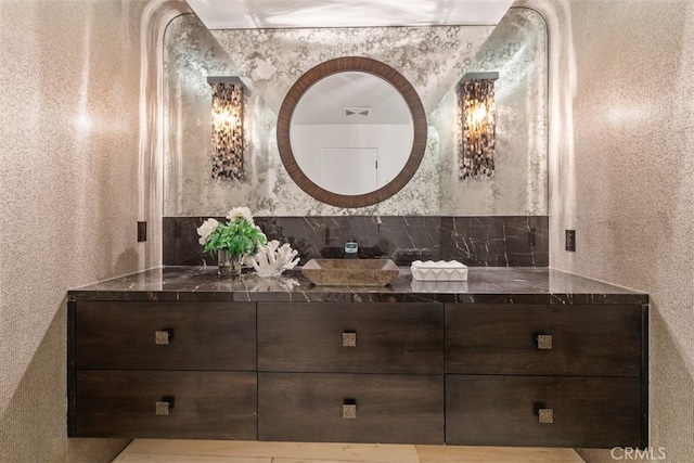 bathroom featuring backsplash and vanity