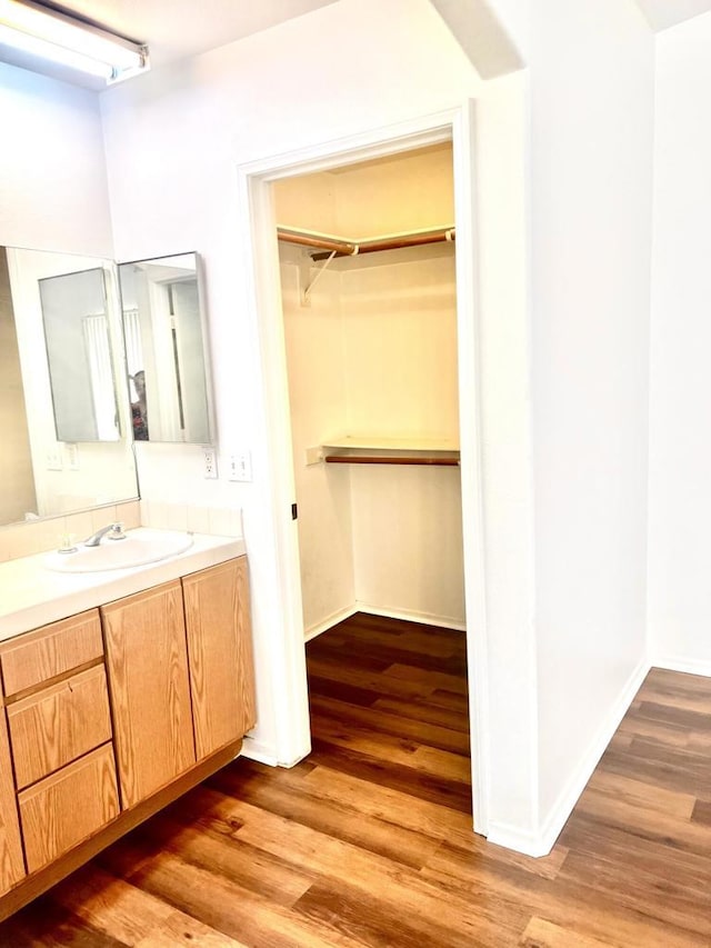 bathroom with hardwood / wood-style floors and vanity