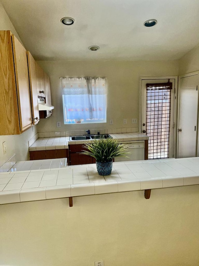 kitchen featuring dishwasher, tile countertops, and plenty of natural light