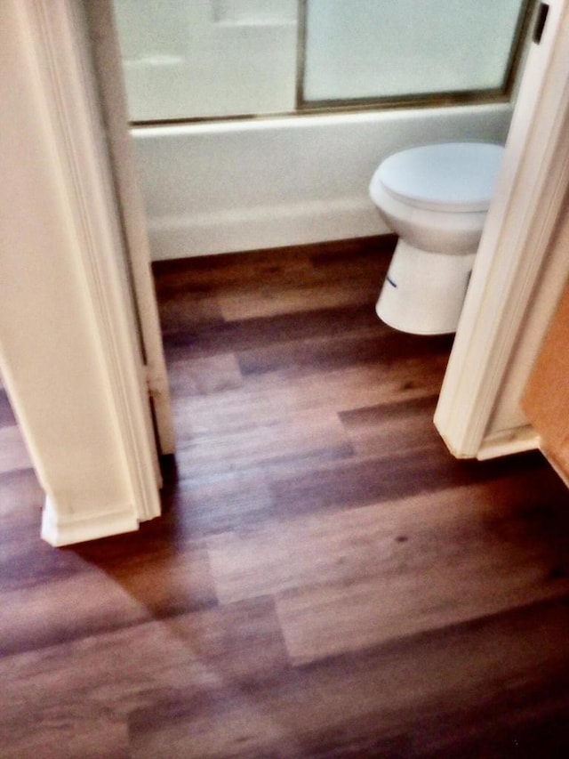 bathroom featuring hardwood / wood-style floors and toilet