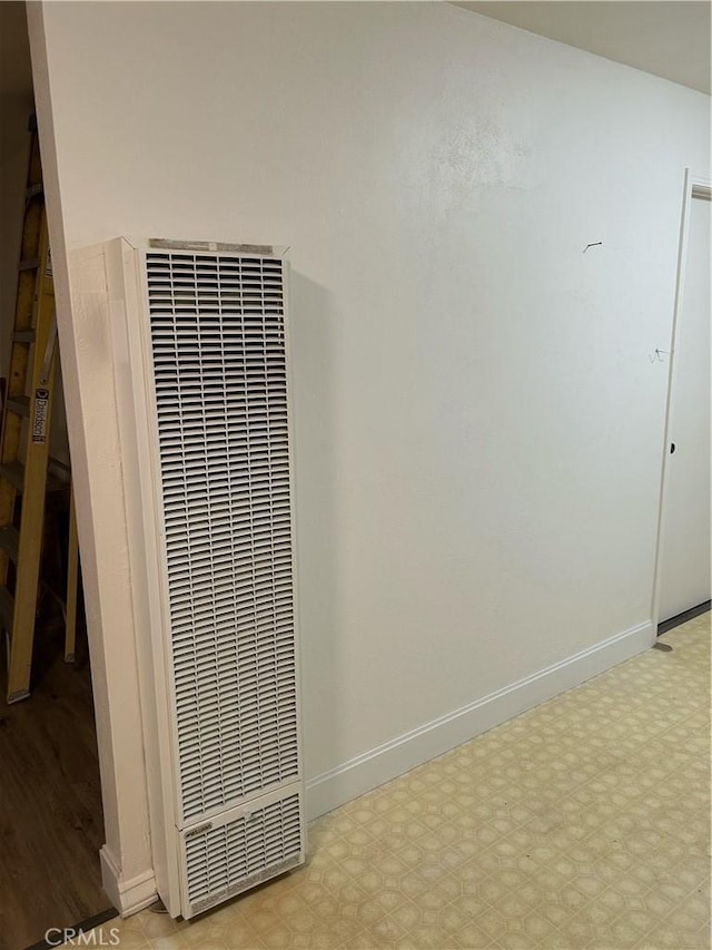 interior details with baseboards and a heating unit