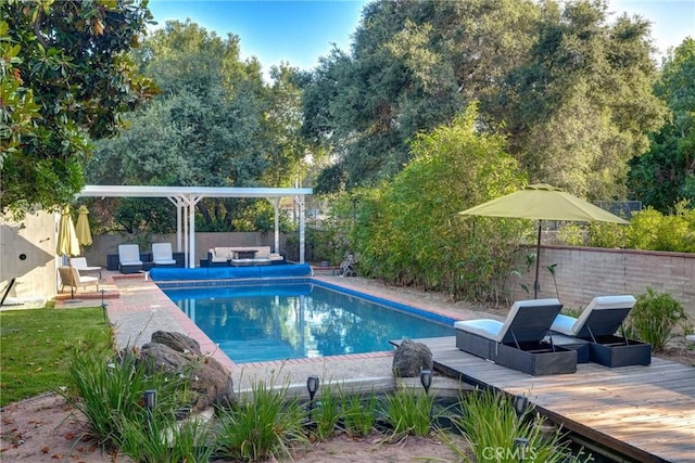 view of pool featuring a wooden deck and an outdoor hangout area