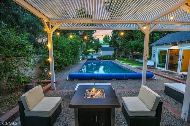 pool at dusk featuring an outdoor structure, a pergola, a patio area, and an outdoor fire pit