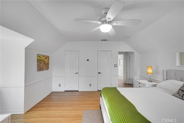 bedroom with vaulted ceiling, ceiling fan, and light hardwood / wood-style floors