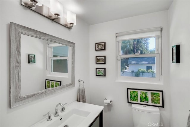 bathroom featuring vanity and toilet