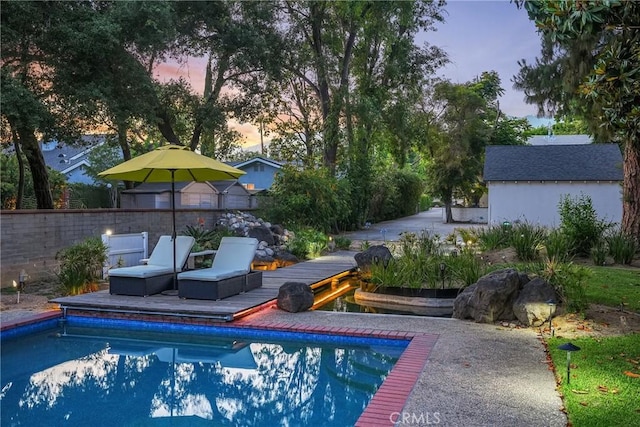 view of pool at dusk