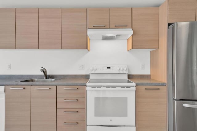 kitchen with stainless steel fridge, light brown cabinets, white range with electric cooktop, and sink