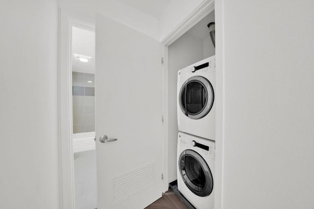 washroom featuring stacked washing maching and dryer